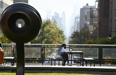 African American student studying at table on Revson Plaza