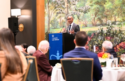 Man at podium speaking to lunch group