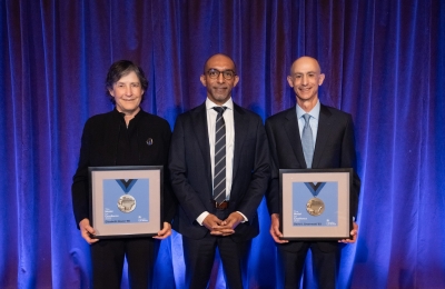Elizabeth Glazer '86, Dean Daniel Abebe, David Greenwald ’83, with framed medals