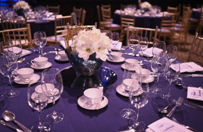 Table set for Winter Luncheon, with dishes, crystal, floral centerpiece