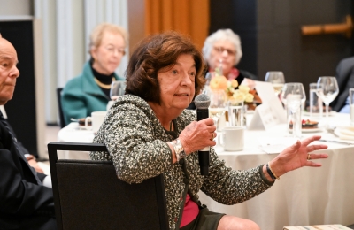 A woman at the luncheon asking a question of the speaker