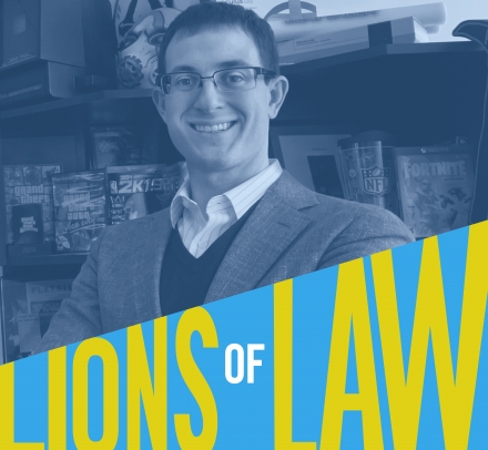 Joshua Simmons in glasses and jacket in front of bookcase with Lions of Law logo at bottom of photograph