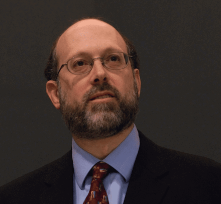 Man with beard in glasses and tie and jacket