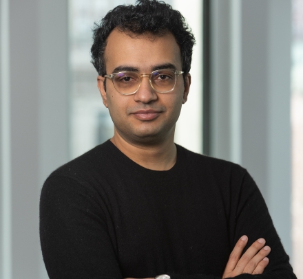 Man in glasses and black sweater with his arms crossed