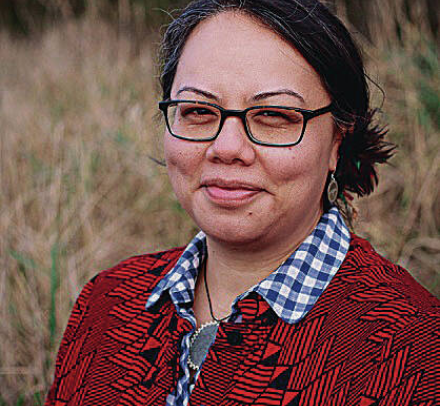 Dark haired woman in red cardigan 