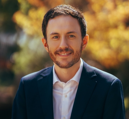 Bearded man in white shirt, dark suit jacket