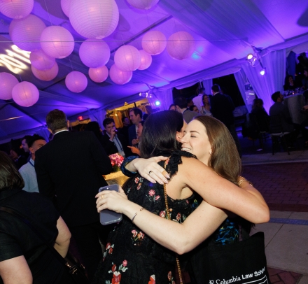 Women hugging in party tent