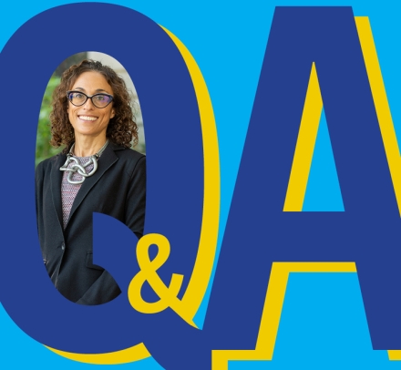 Graphic Q&A with inserted photo of smiling dark haired woman with glasses. 