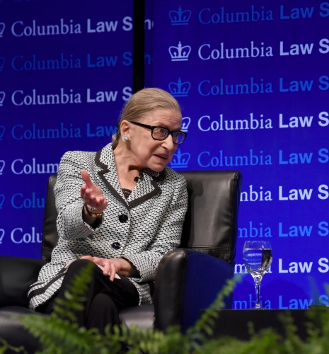 Ruth Bader Ginsburg sitting in front of Columbia Law School step and repeat
