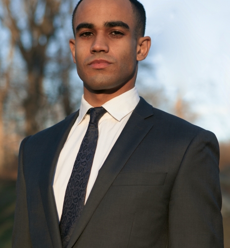 Man in dark suit and tie and white shirt