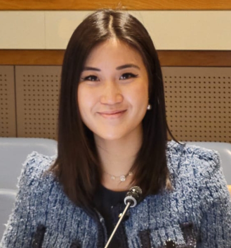 Gillian Ho wearing a suit and smiling