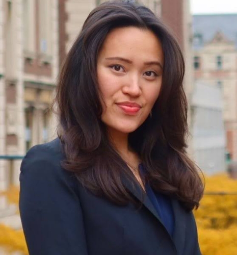 Claire Atkerson smiling in front of a Columbia building.