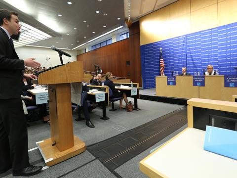 A students stands in front of three judges in Moot Court.
