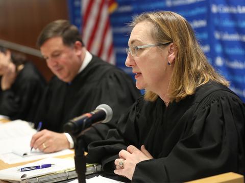 A judge speaks into a microphone at Moot Court.