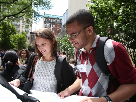 Two students look at lists outside the Law School.
