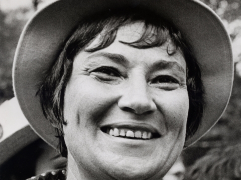 Black and white headshot of Bella Abzug smiling 