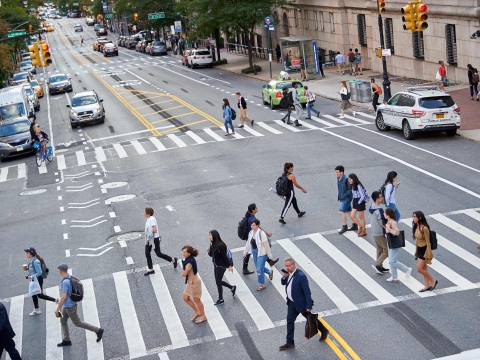 Student cross Amsterdam Avenue at the crosswalk.