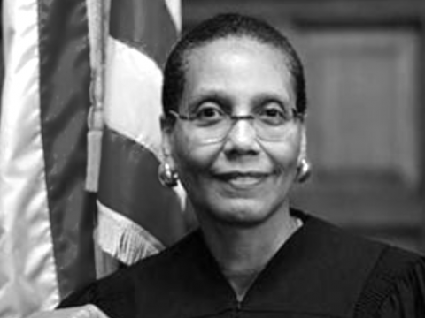 Judge Sheila Abdus-Salaam BAR ’74, LAW ’77 stands in front of an American flag.