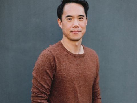 Dark-haired man in brown sweater