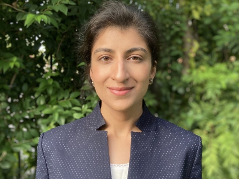 Columbia Law professor Lina Khan in blue jacket and white camisole