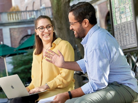 Students outside with a computer