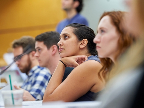 A student leans forward during a lecture class
