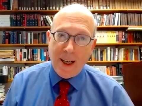 Philip Hamburger speaks in front of a bookshelf