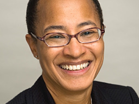 Woman with glasses and cropped haircut