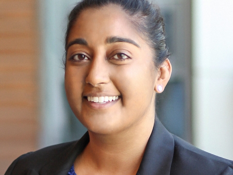 Woman in a blue blouse and black blazer