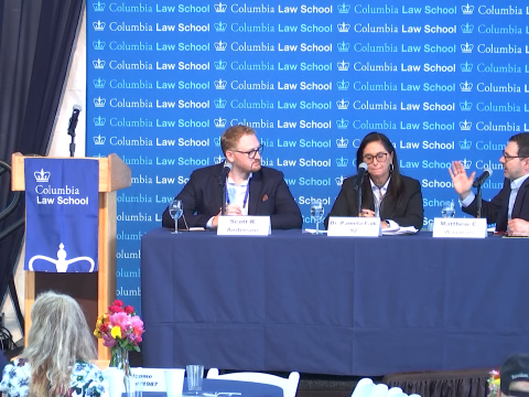Three people sitting in front of a Columbia Law School backdrop