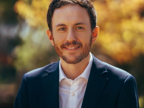 Bearded man in white shirt, dark suit jacket