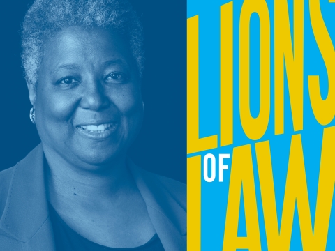 Woman with gray curly hair in jacket with Lions of Law headline