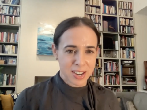 Kate Judge in front of bookshelves