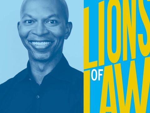 Man smiling next to Lions of Law logo
