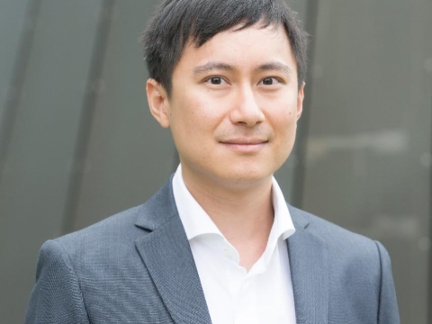 Man in white shirt and gray jacket