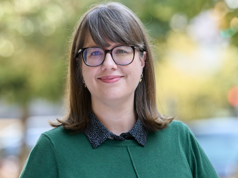 Woman wearing glasses and a green sweater