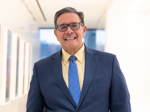 Man with glasses in blue suit and blue tie