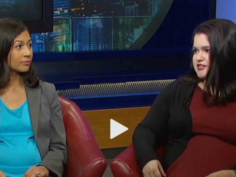 Professor Elora Mukherjee and student Angelica Juarbe sit in chairs in an interview. The news chyron at the bottom of the scream reads Defending Illegal Aliens.