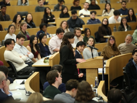 A speaker at a podium in a classroom