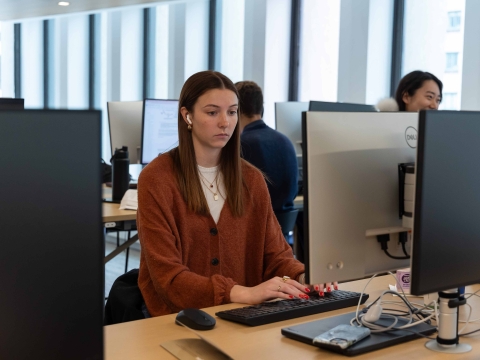 A student works on a desktop computer in the new library.