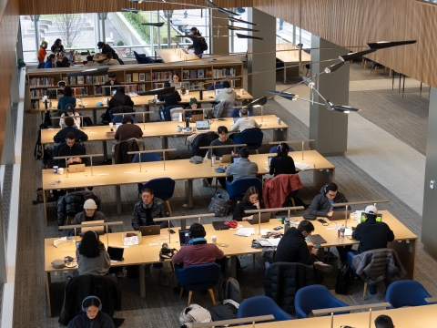 Looking down at students sitting at long tables