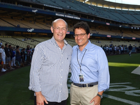 Stan Kasten and Mark Attanasio stand in Dodger Stadium.