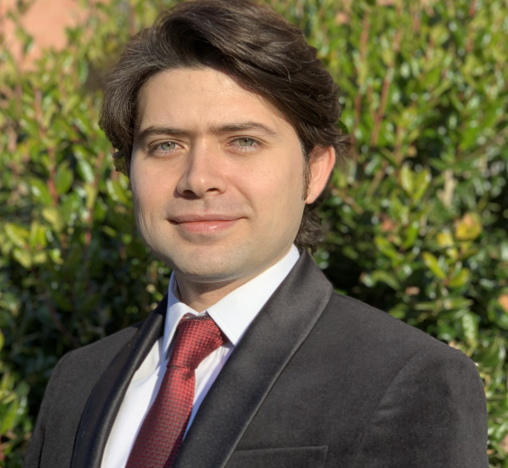 Dark-haired man in suit and tie