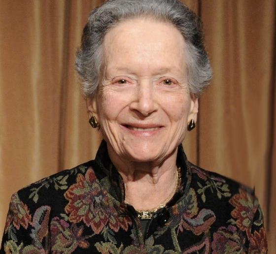 Woman with gray hair in dark flowered jacket