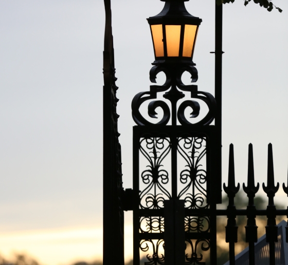 A lamp post with the Columbia crown on at the gates of campus