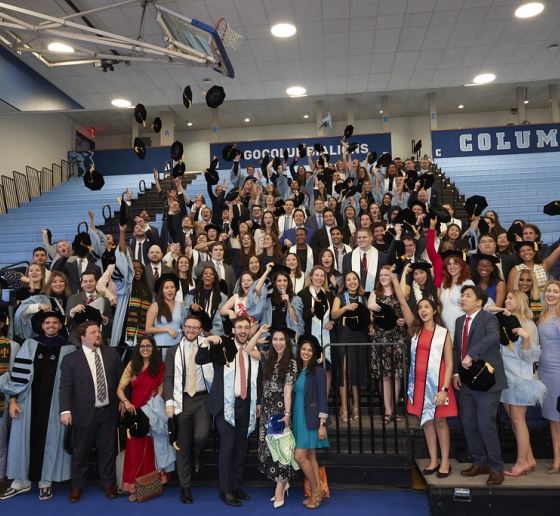 Members of the Classes of 2021 and 2020 standing on bleachers