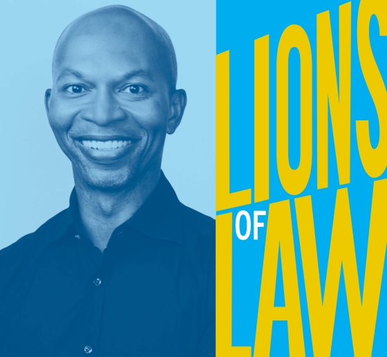 Man smiling next to Lions of Law logo