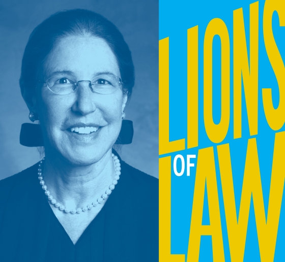 Woman in judge's robe and pearls with Lions of Law text
