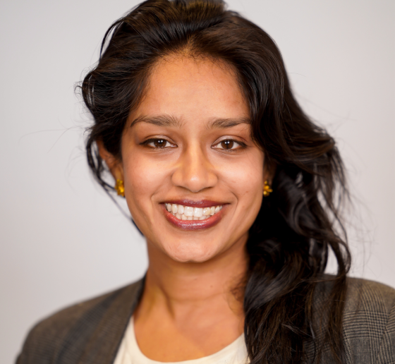 Smiling woman with long dark hair, in dark jacket