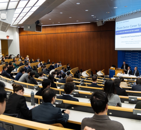 Full classroom of students listening to panel discussion